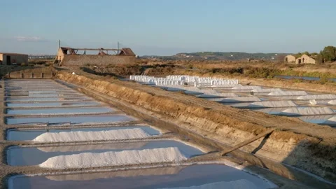 Sunset cinematic shot of salt fields after a full day of collecting salt Stock Footage 171367388