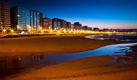 Sunset on a city beach Stock Photos