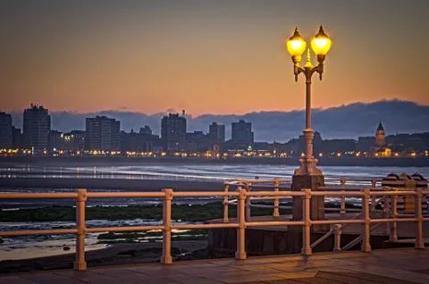Sunset on a city beach Stock Photos