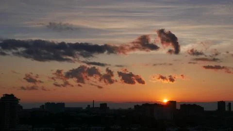 Sunset in the city. Clouds in the light of the setting sun Stock Photos