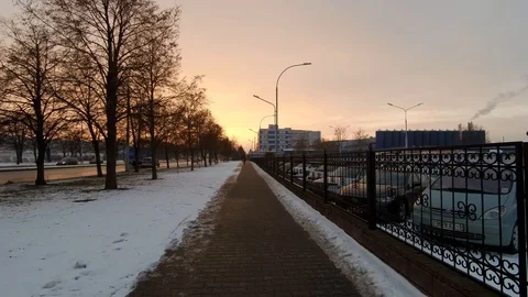 Sunset in the city, man passes by,4K Stock Footage 103208264