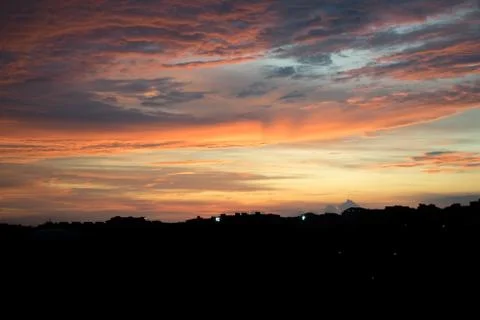 Sunset on the city sky Stock Photos