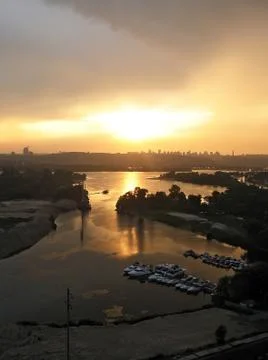 Sunset in the city view from the window. River View in city Kiev. Bay with boats Stock Photos
