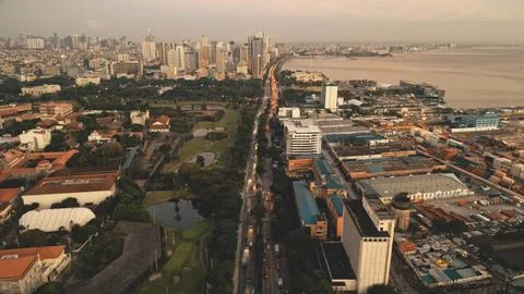 Sunset cityscape with designed park and ponds at ocean bay aerial. Port town of 写真素材