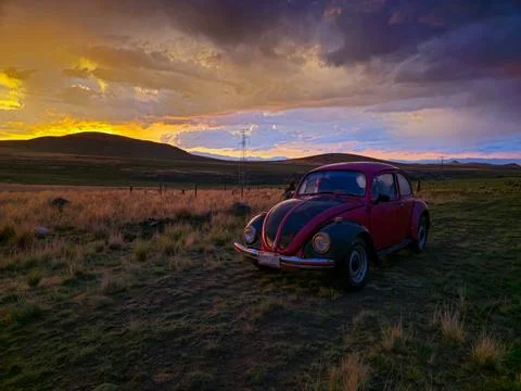 Sunset with a classic car in the foreground Stock Photos