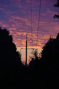 Sunset on a clearing under high-voltage wires Stock Photos