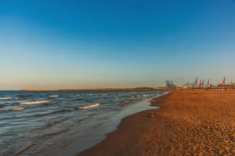 The sunset clock on the beach of Malvarros on a clear day. Valencia, Spain Stock Photos