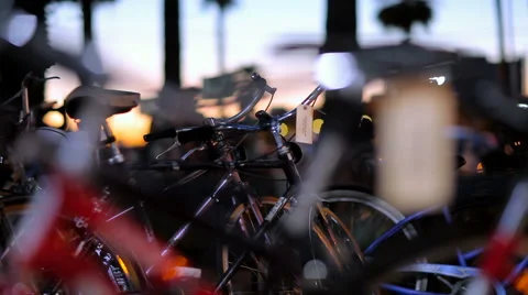 Sunset Close-Up Parked Bikes Active People in the Background Stock Footage 61438707