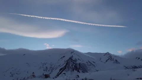 Sunset Cloud Contrail at winter snowy mountains Stock Footage 104220704