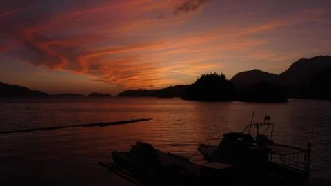 Sunset with cloud pattern and boat in foreground Stock Photos