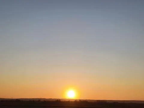 Sunset on a cloudless winter day - the view reaches to the horizon Stock Photos