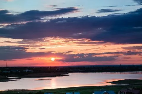 Sunset in the clouds above the Bay on a background of the blue sky Stock Photos