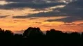 The sunset clouds above forest, time lapse HD Footage