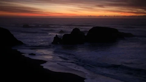 Sunset clouds above a rocky island off the coast of northern California Stock Footage 76596336