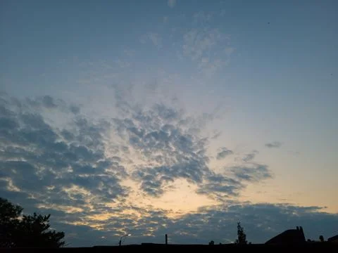 Sunset with clouds in an abstract landscape. Stock Photos