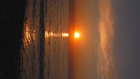 Sunset in clouds against background of sea or ocean. Video stock 241103423