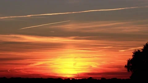 Sunset clouds with airplane contrail Stock Footage 221495320