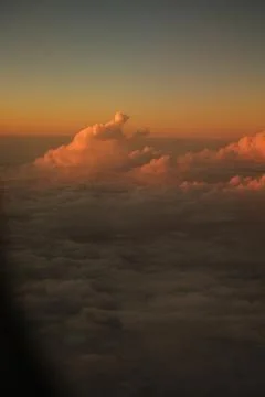 Sunset in clouds from airplane Stock Photos