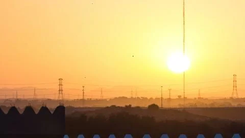 Sunset with clouds in Ajman cityscape from rooftop timelapse. Ajman is the ca Stock Photos