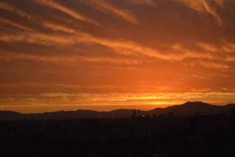 Sunset clouds and cityscape 库存照片