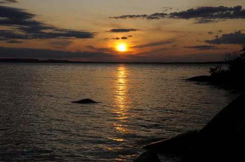 Sunset, clouds and distant island Stock Photos