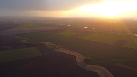 Sunset, clouds and fields from a height in summer. Stock Photos
