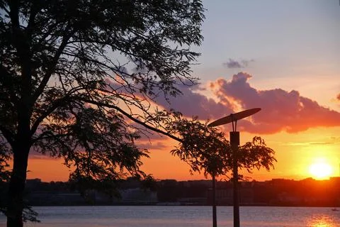 The sunset with the clouds and the lamp Stock Photos