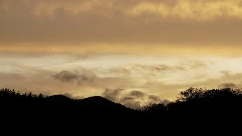 Sunset clouds and mountains Stock Photos
