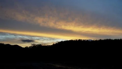 Sunset clouds and mountains Stock Photos