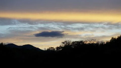 Sunset clouds and mountains Stock Photos
