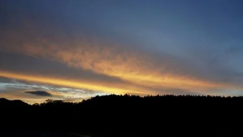 Sunset clouds and mountains Stock Photos
