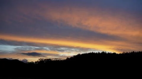 Sunset clouds and mountains Stock Photos
