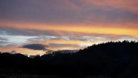 Sunset clouds and mountains Stock Photos