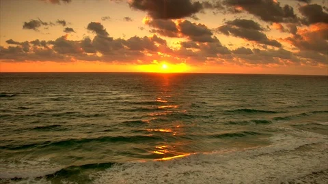 Sunset. Clouds and ocean waves view from beach. pan up Stock Footage 102532287