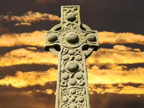 Sunset clouds and a stone cross composite. Stock Photos