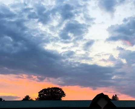 Sunset with clouds and trees Stock Photos