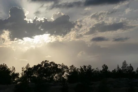 Sunset, clouds, crepuscular rays, over mountain Stock Photos