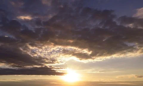 Sunset clouds in dark sky. Sunset sky with cirrus clouds. Dramatic sunset with Stock Photos