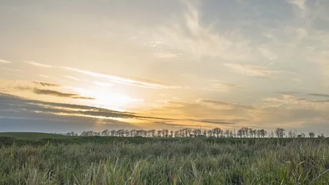 Sunset clouds at field in spring. Time lapse Stock Footage 108180537