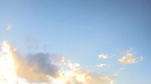 Sunset Clouds float on blue sky timelapse Stock Footage
