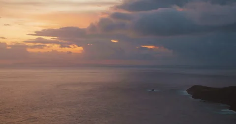 Sunset clouds float over calm ocean horizon in Bali Nusa Penida Indonesia Stock Footage 345688830