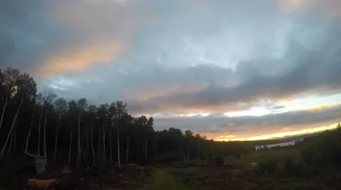 Sunset clouds flow over Canadian ranch in time-lapse sequence 動画素材 56207690