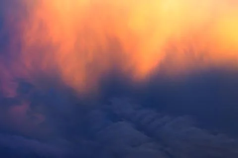 The sunset clouds, gilded by the setting sun Stock Photos