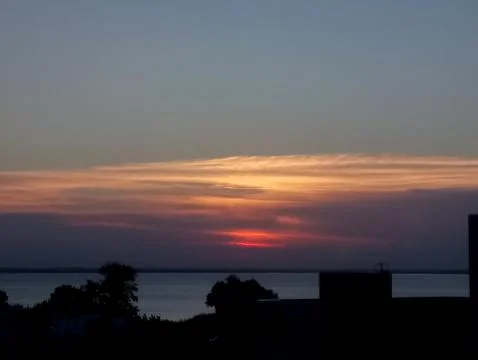 Sunset in the clouds on the lake Stock Photos