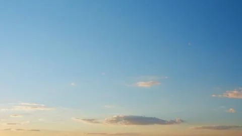 Sunset with clouds in motion. Summer sky at sunset with clouds. Timelapse. Stock Photos