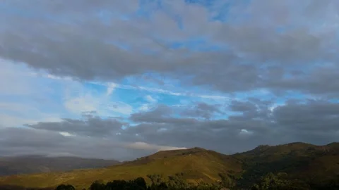 Sunset Clouds Moving Over Rolling Mountain Ridges. Видео 347266098