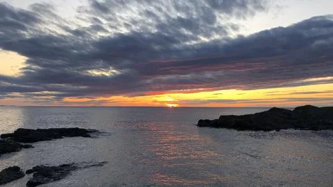 Sunset with clouds over the bay looking onto the Atlantic ocean. Stock Photos