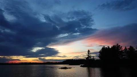 Sunset with clouds over calm lake Video stock 156066076