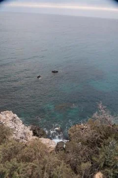Sunset with clouds over Golden bay, Malta and turquoise water Stock Photos