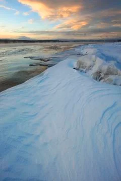 Sunset clouds over the icy shores of Teslin Lake, Teslin, Yukon Stock Photos